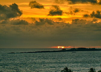 On a cloudy Bahamas morning, the Atlantic Ocean was calm at sunrise, reflecting a gorgeous array of colors in the sky
