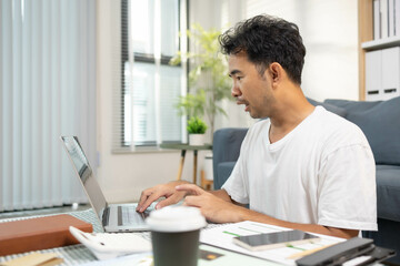 
A man spends his vacation paying bills with his laptop, coffee cups and credit cards, and he is looking for a moment to relax after all this activity.
A man spends his vacation paying bills with his
