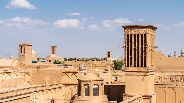 Yazd cityscape featuring traditional mudbrick buildings, iconic windcatcher towers, and Iranian architecture