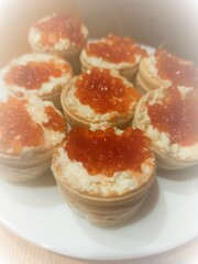 Canape with red caviar in butter. 