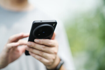 asian farmer using smart phone in greenhouse