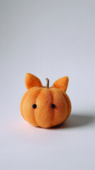 Cute pumpkin with tiny hand sewn ears on white background