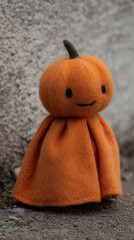 Cute pumpkin with handmade felt cape, smiling expression