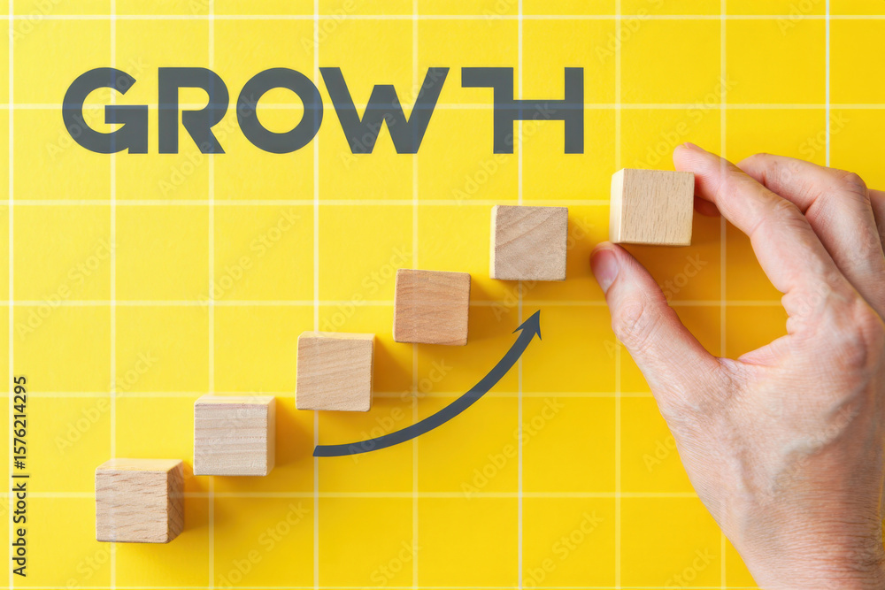 Poster conceptual image of wooden blocks arranged as steps leading to growth with hand placing the final bl