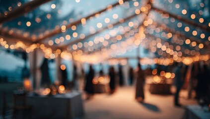 Blurred background of an outdoor wedding fair with fairy lights and tents, creating a festive atmosphere. 