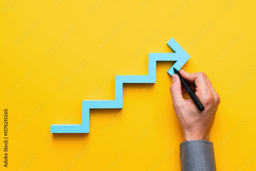 Poster conceptual image of a hand drawing a blue arrow on a yellow background representing progress and dir