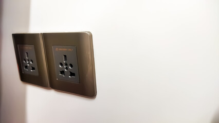 Electric plug and power sockets, power outlets in a train interior, close-up shot.