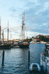sailing boats in the harbor of helsinki at sunset time with great old big boats 