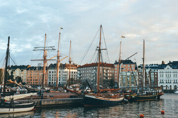 sailing boats in the harbor of helsinki at sunset time with great old big boats 
