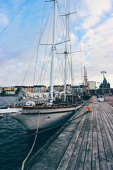 sailing boats in the harbor of helsinki at sunset time with great old big boats 