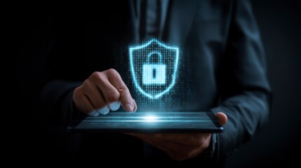 A man is holding a tablet with a blue shield on it. The shield is a symbol of security and protection