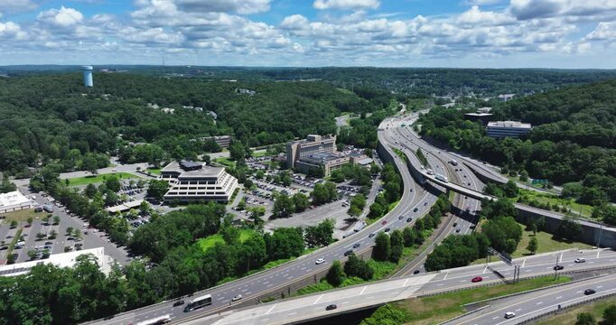 Elmsford, NY, US - July 9, 2025.  Afternoon aerial video over the Elmsford, NY, local commercial buildings and Interstate 87 and 287