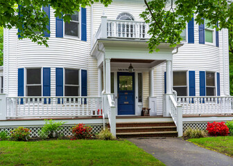 Elegant American house with blue shutters and curved facade in Newton, Massachusetts, USA
