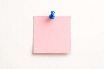 Minimalist Pink Sticky Note on White Wall — Reminder or Message Concept