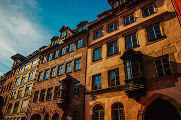 Old architectural building in Nuremberg city against blue bright sky. Cityscape