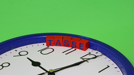 Word TAXES in Italian Wooden cubes with clock time