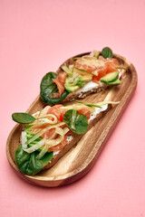 Healthy smoked salmon and cream cheese open-faced sandwich with fresh vegetables