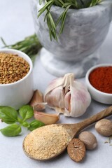 Different aromatic spices on light grey table