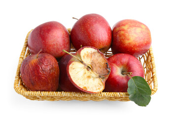 Spoiled apple and good ones in basket isolated on white