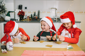 Children joyfully decorating christmas gingerbread cookies