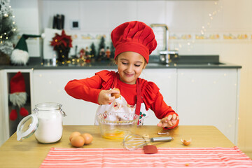 Young chef joyfully preparing christmas cookies