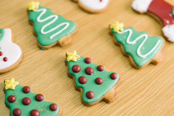 Festive christmas tree cookies on wooden table