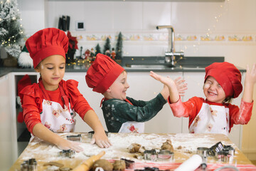 Children joyfully baking christmas cookies together