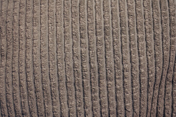 The image is of a fuzzy, brown fabric with a striped pattern