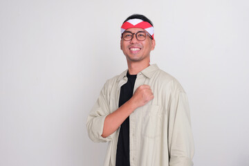 Indonesian man celebrate independence day showing proud gesture with hand on chest