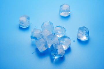  ice cubes on a blue.