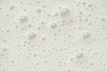 Fototapeta premium A serene pattern of white bubbles on a light gray background, symbolizing purity and cleanliness