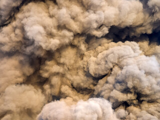 Toxic black smoke from fire against sky burning plastic