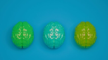 Set of three colorful reflective brains on blue background