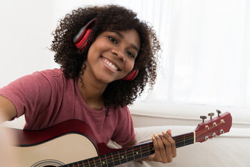 Music, woman and playing guitar for song and looking camera selfie photo. African American woman...