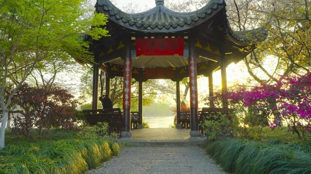 Chinese pavilion and sunrise by the West Lake in spring