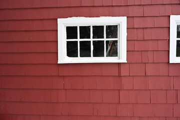 red and white barn window in the snow 