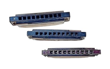 Three diatonic harmonicas labeled A and C arranged on a white background