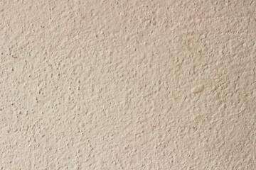 A light beige or cream stucco wall surface with a slightly rough texture, ideal for a simple and...