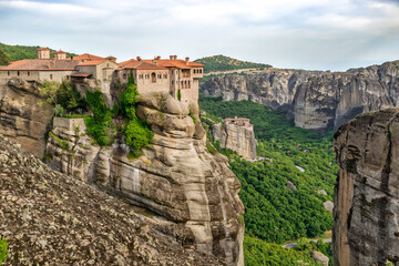 Panoramic view of the Varlaam and Rousanou Monasteries, dramatically built atop monolithic rock formations in Meteora, Greece