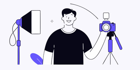 A smiling photographer stands with a camera and lighting equipment in a studio setting, perfect for photography business concepts and design projects.
