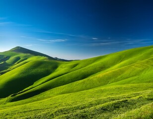 Obraz premium a vibrant green hillside under a clear blue sky wallpaper