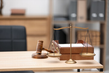 Judge's gavel, scales and document tray on wooden table in office, space for text