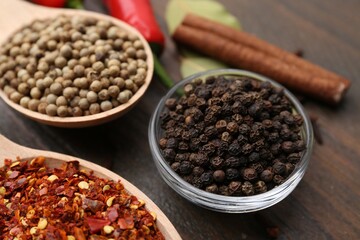 Different aromatic spices on wooden table, closeup