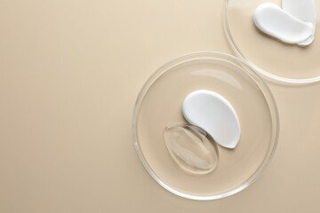 Different cosmetic products in Petri dishes on beige background, flat lay. Space for text