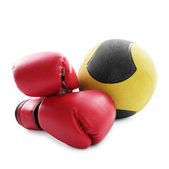 Medicine ball and boxing gloves isolated on white