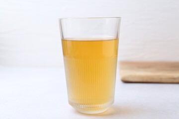 Glass with dirty water on light table, closeup