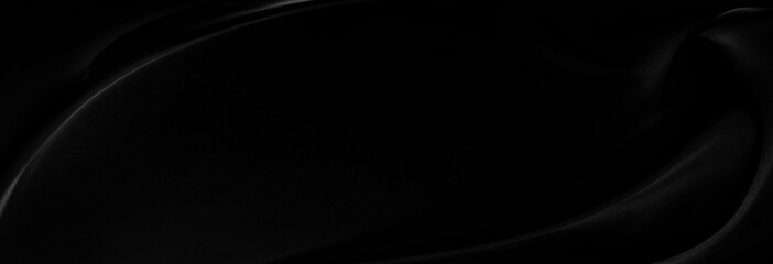 Black gray satin dark fabric texture luxurious shiny that is abstract silk cloth panorama background with patterns soft waves blur beautiful.