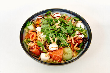Fresh arugula and smoked salmon salad with mozzarella and pine nuts