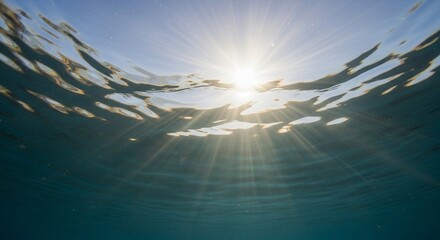 Fototapeta premium Sunbeams dance through the water, creating a mesmerizing underwater spectacle
