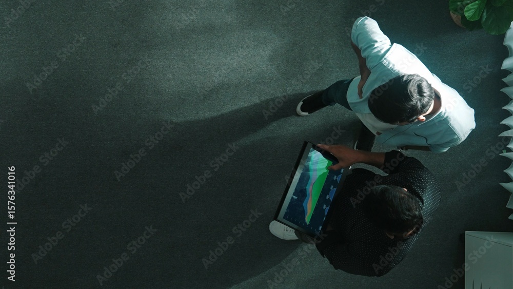 Aufkleber top down view of manager stand with investor while holding tablet and looking at financial statistic